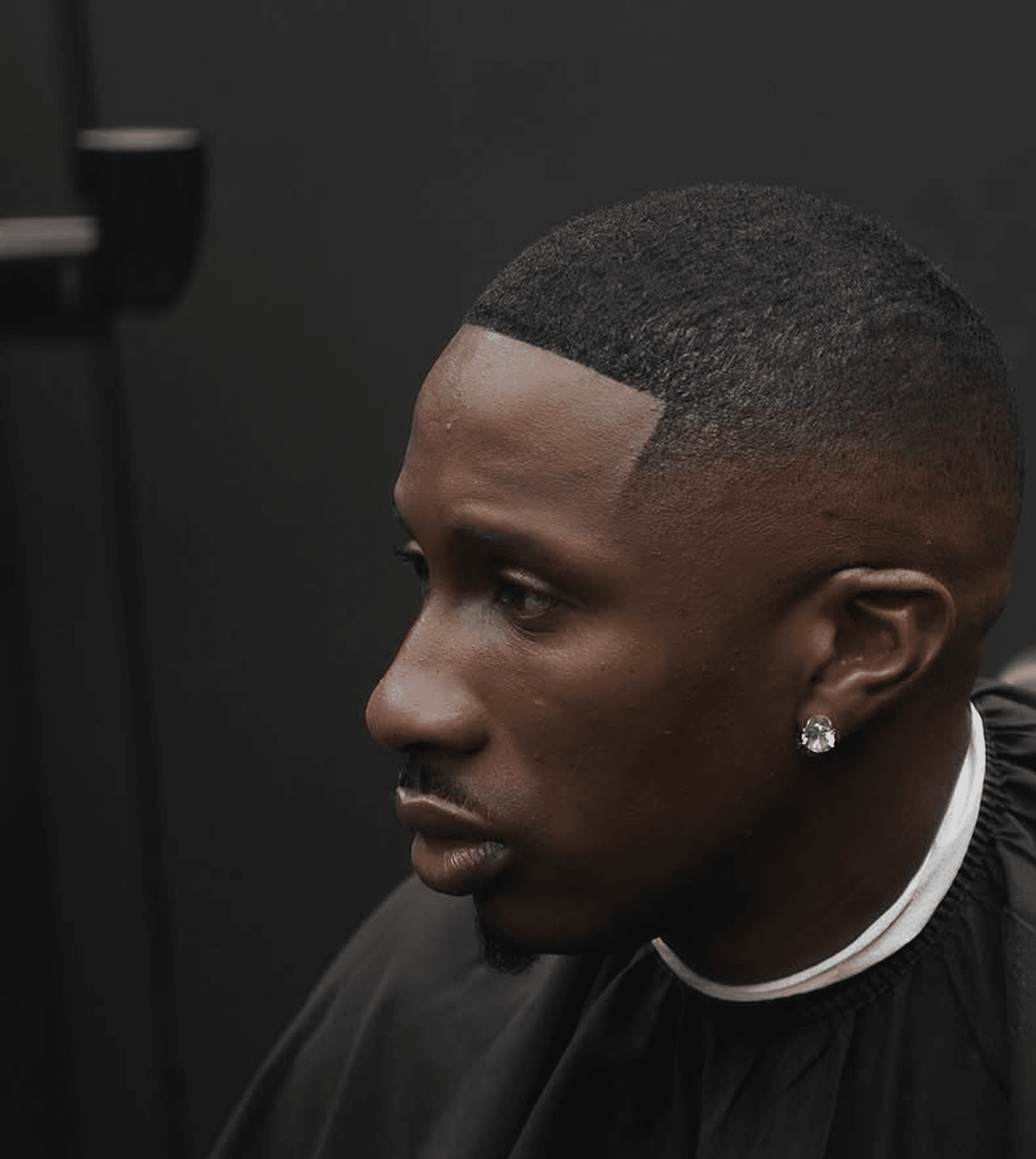 Client receiving a precision VIP haircut in studio