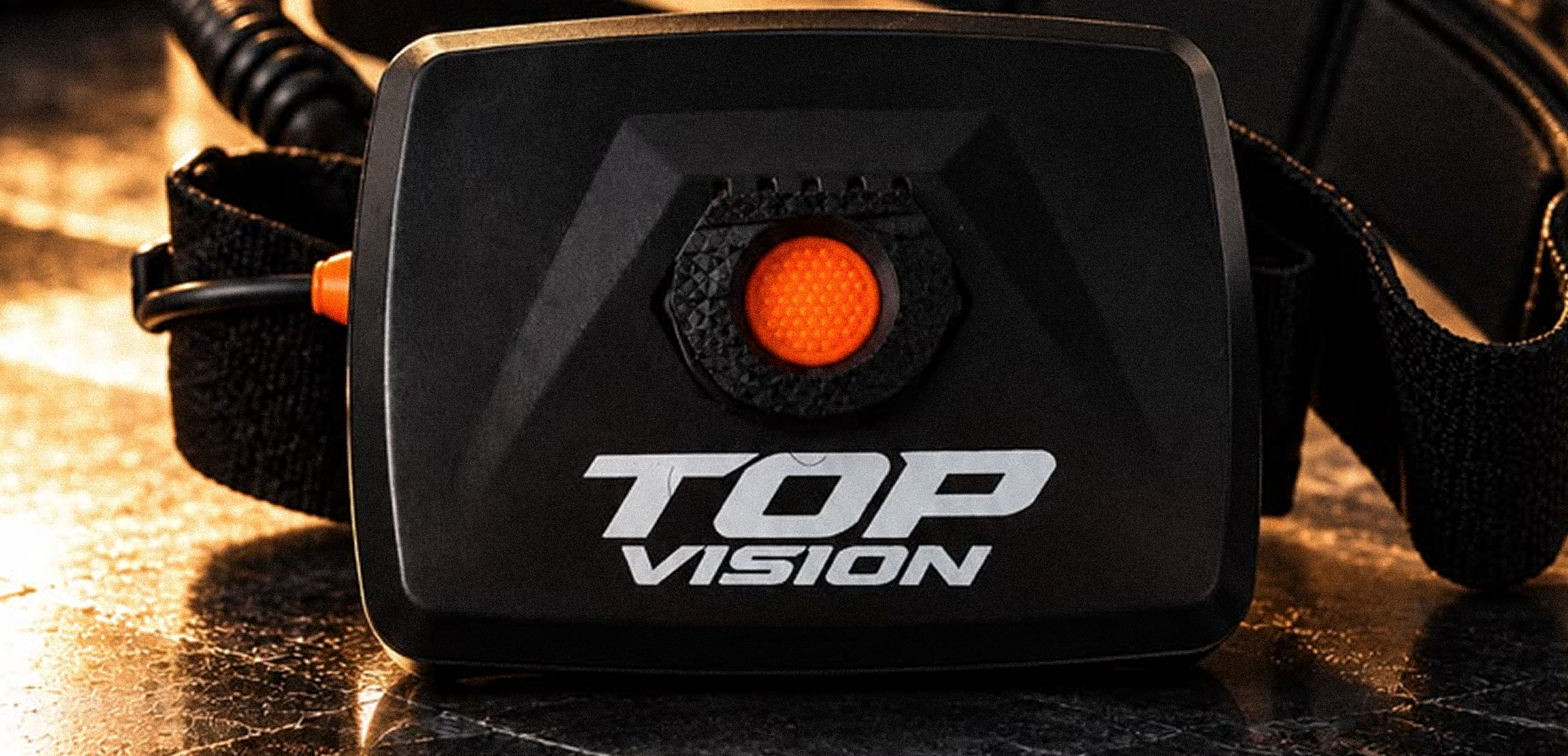 Close up of Top Vision headlamp battery unit and power button